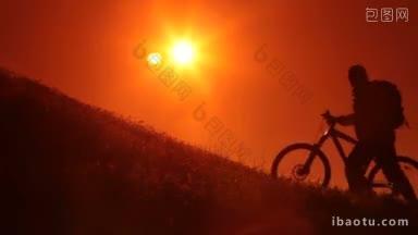 骑车人骑着自行车进入初升的太阳剪影